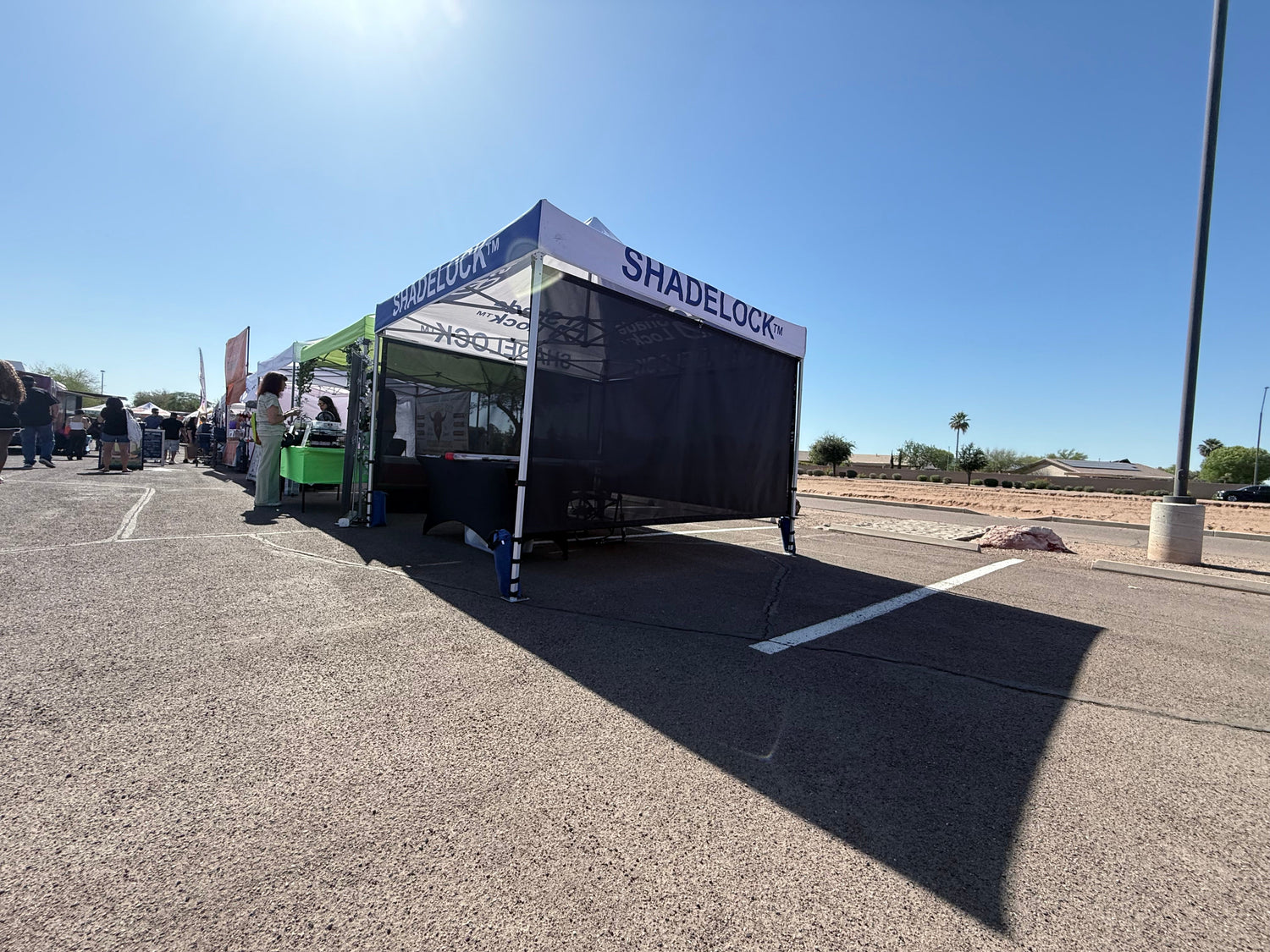 ShadeLock™ Low-Angle Sun Shade System installed on a commercial canopy structure.